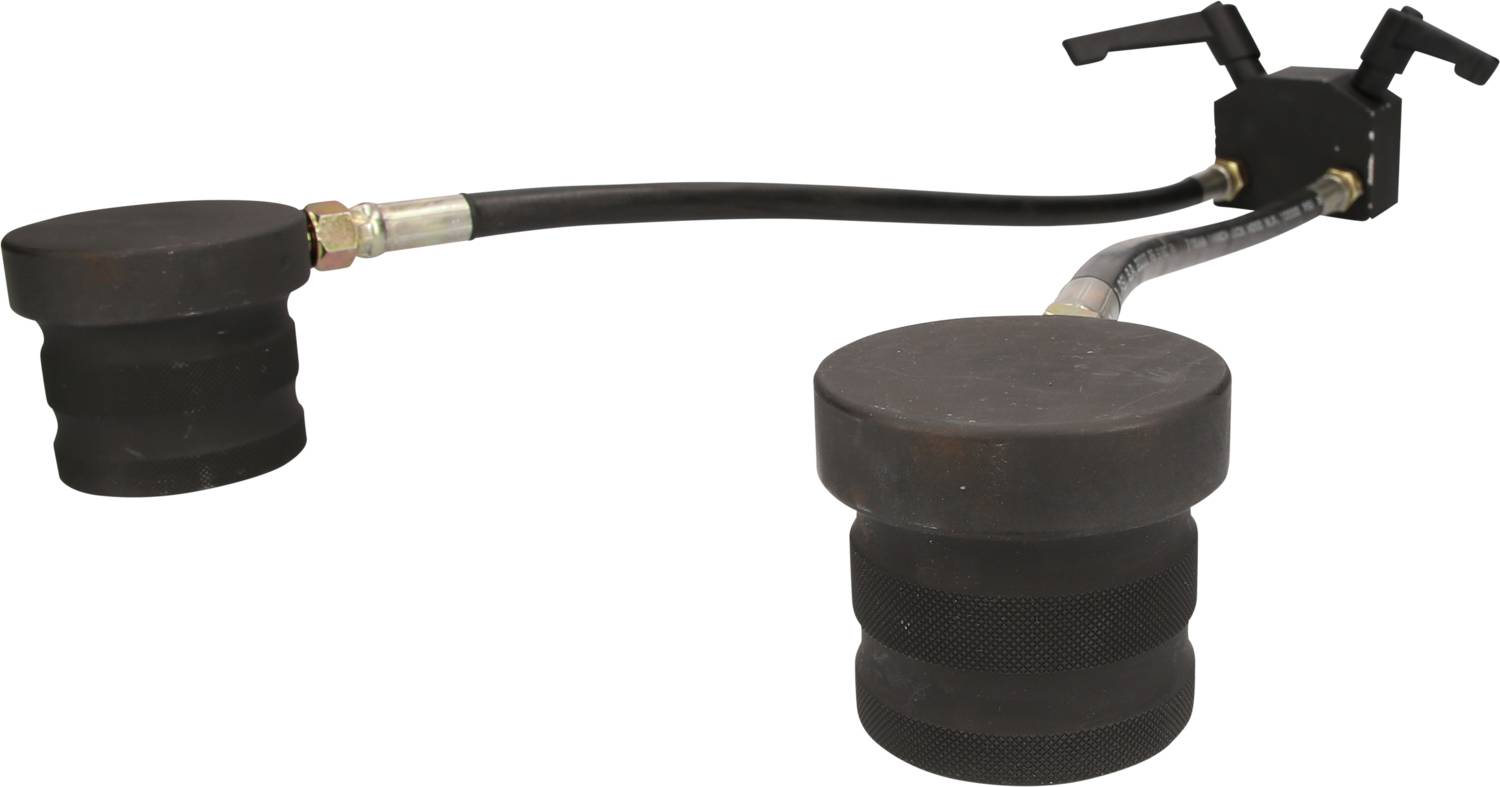 Ein hydraulisches Werkzeug mit zwei schwarzen Gummikappen, verbunden durch Schläuche, dient zum Verschließen von Rohrleitungen.