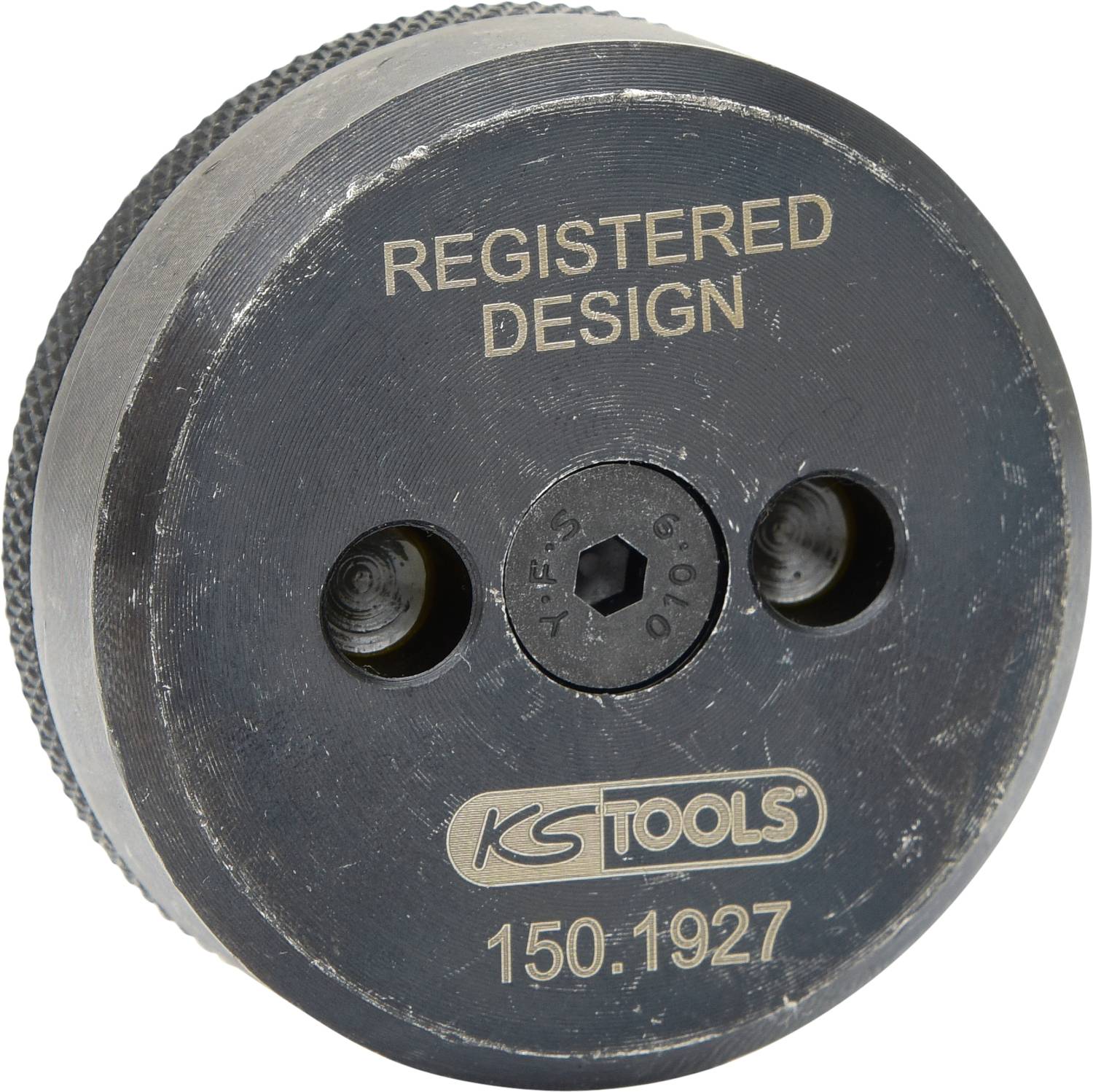Werkzeugteil mit Aufschrift 'REGISTERED DESIGN' und 'KS TOOLS 150.1927', runde Form, Metall, zwei Löcher im mittleren Bereich.