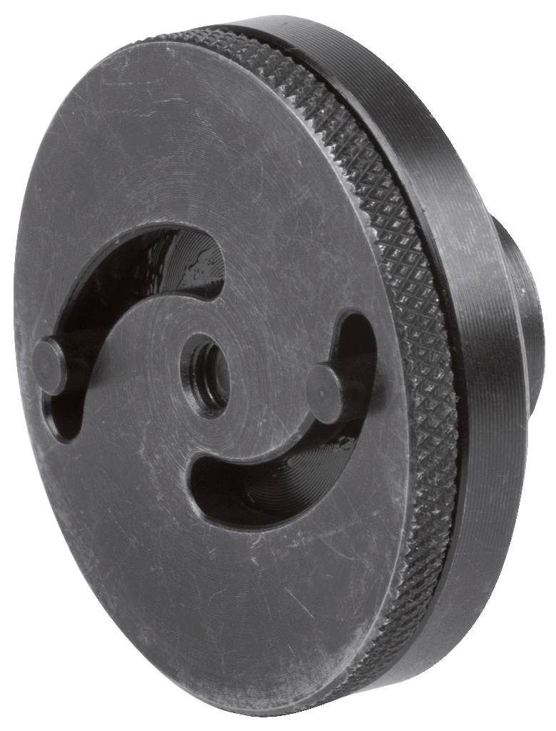 Metallteil mit runder, gerändelter Oberfläche und zwei gebogenen Schlitzen. Hauptsächlich technische Anwendung.