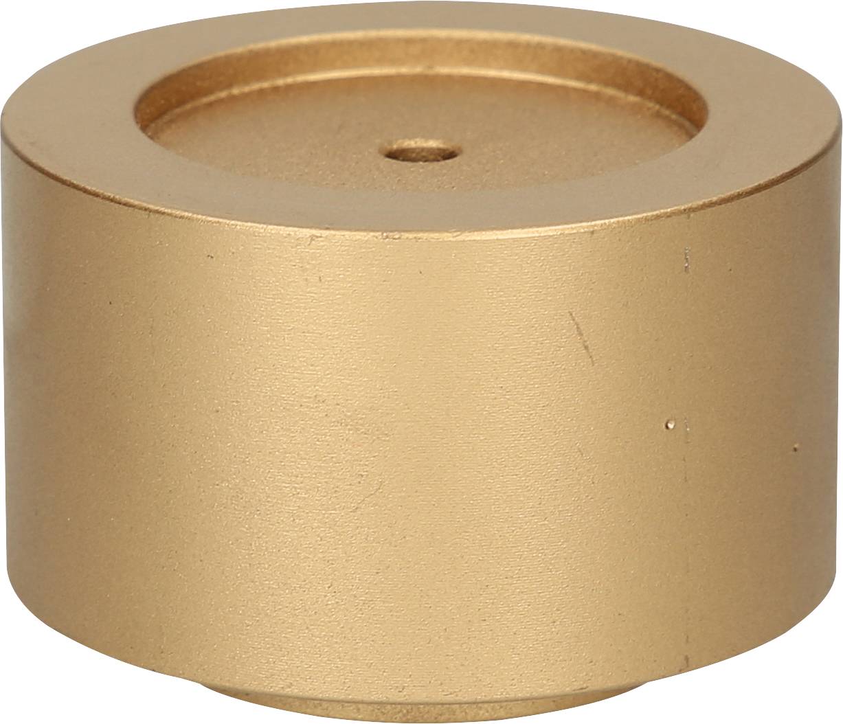 Goldener zylindrischer Metallblock mit einem Loch in der Mitte, auf einer weißen Hintergrundfläche liegend.