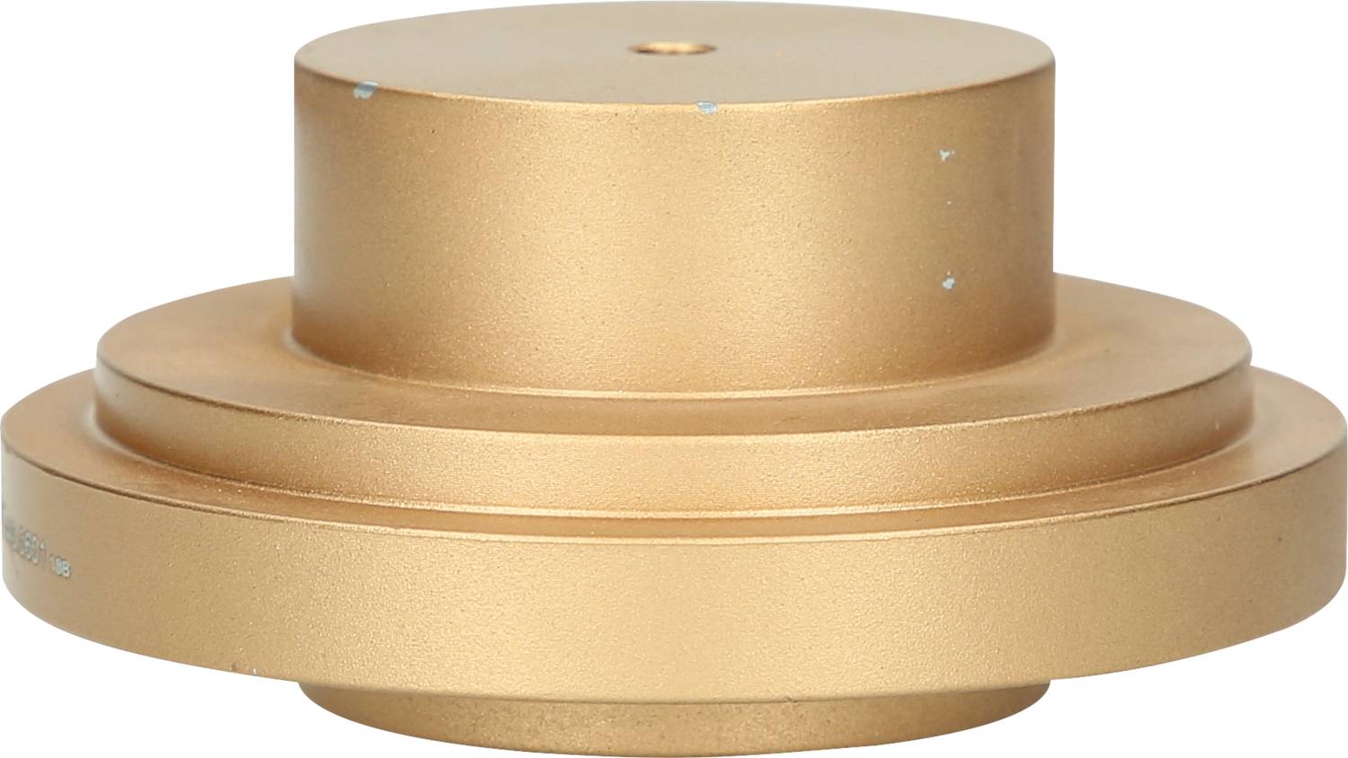 Goldenes, zylindrisches Objekt, ähnlich einem Türstopper oder Maschinenteil, ohne erkennbare Funktionen oder Aufschriften.