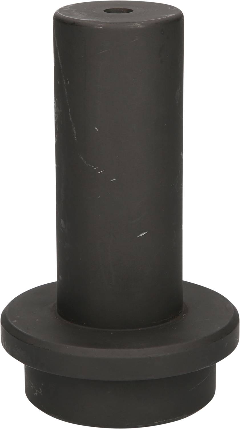 Ein zylindrisches schwarzes Objekt mit einem breiten Sockel und einem schmalen, vertikalen Körper, möglicherweise eine Gummipufferkappe.