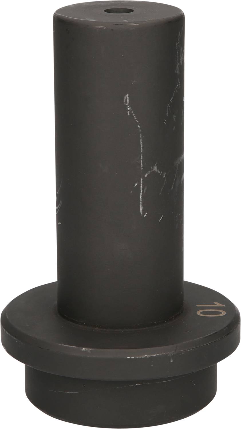Schwarzes Metallteil mit zylindrischer Form und breitem Ring am Fuß, aufrecht stehend. Oberflächliche Kratzer sichtbar.