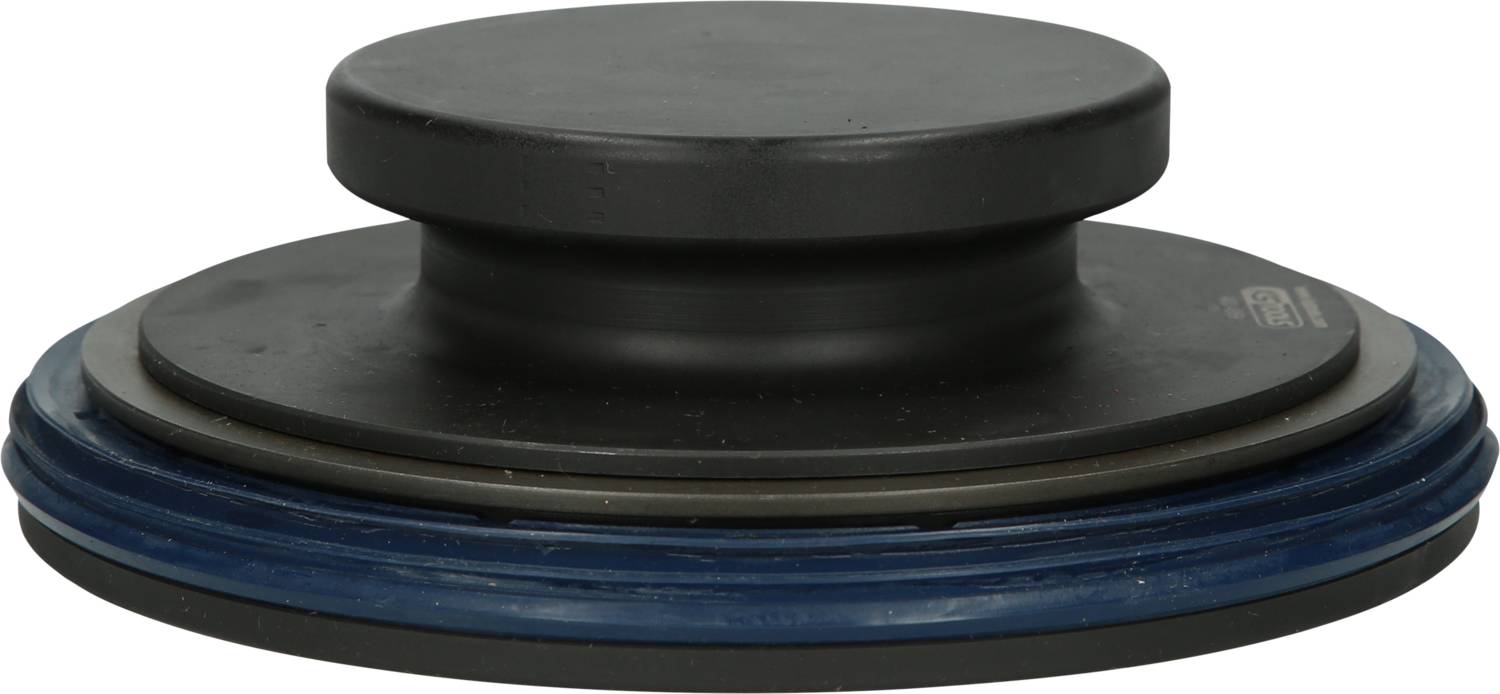 Ein flacher, runder Metallgegenstand, möglicherweise ein Maschinenteil oder Gewicht, mit dunkler Oberfläche und blauer Basis.