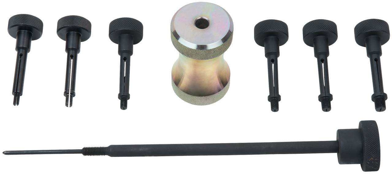 Eine Reihe von Werkzeugen, darunter ein zylindrisches Metallteil und mehrere schwarze Stabteile, vermutlich zur Auto- oder Maschinenwartung.