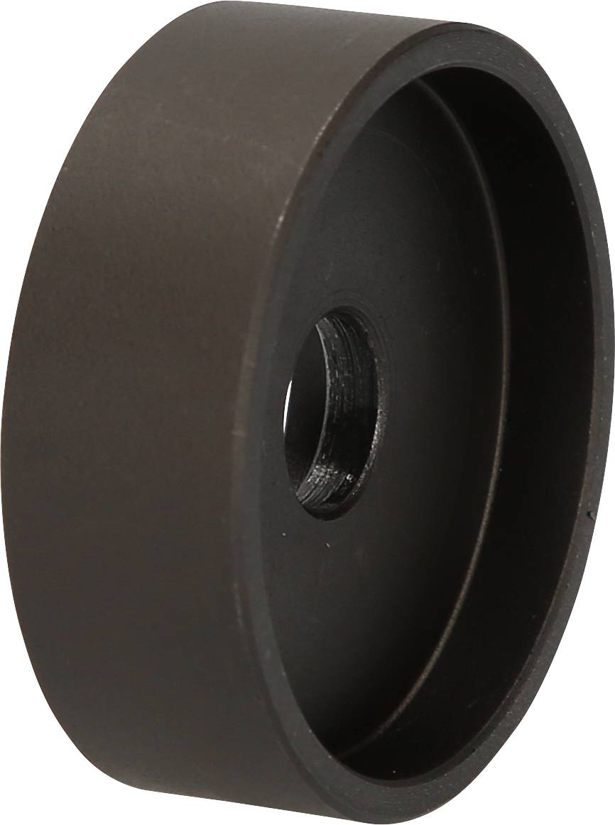 Eine schwarze, runde Metallkomponente mit zentraler Bohrung. Sie könnte Teil eines Mechanismus oder einer Halterung sein.