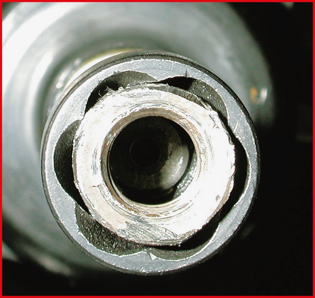 Nahaufnahme eines abgenutzten Metallrohrs mit inneren Beschädigungen und herausragenden Kanten, aufgenommen von vorne.