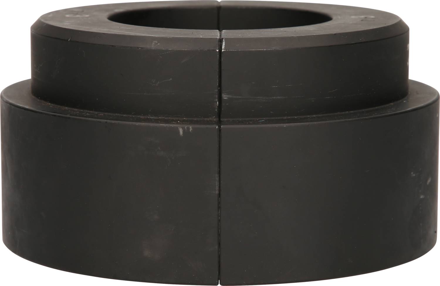 Zylinderförmiges, schwarzes, zweiteiliges Bauteil mit einer zentralen Öffnung, möglicherweise ein technischer oder mechanischer Teil.
