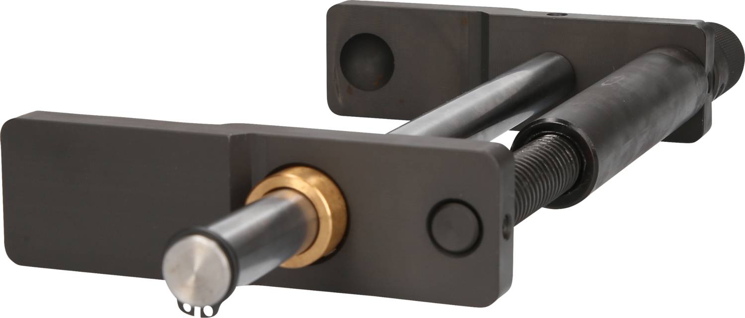 Ein schwarzes mechanisches Gerät mit zwei parallelen zylindrischen Stangen und einem messingfarbenen Verbindungselement in der Mitte.