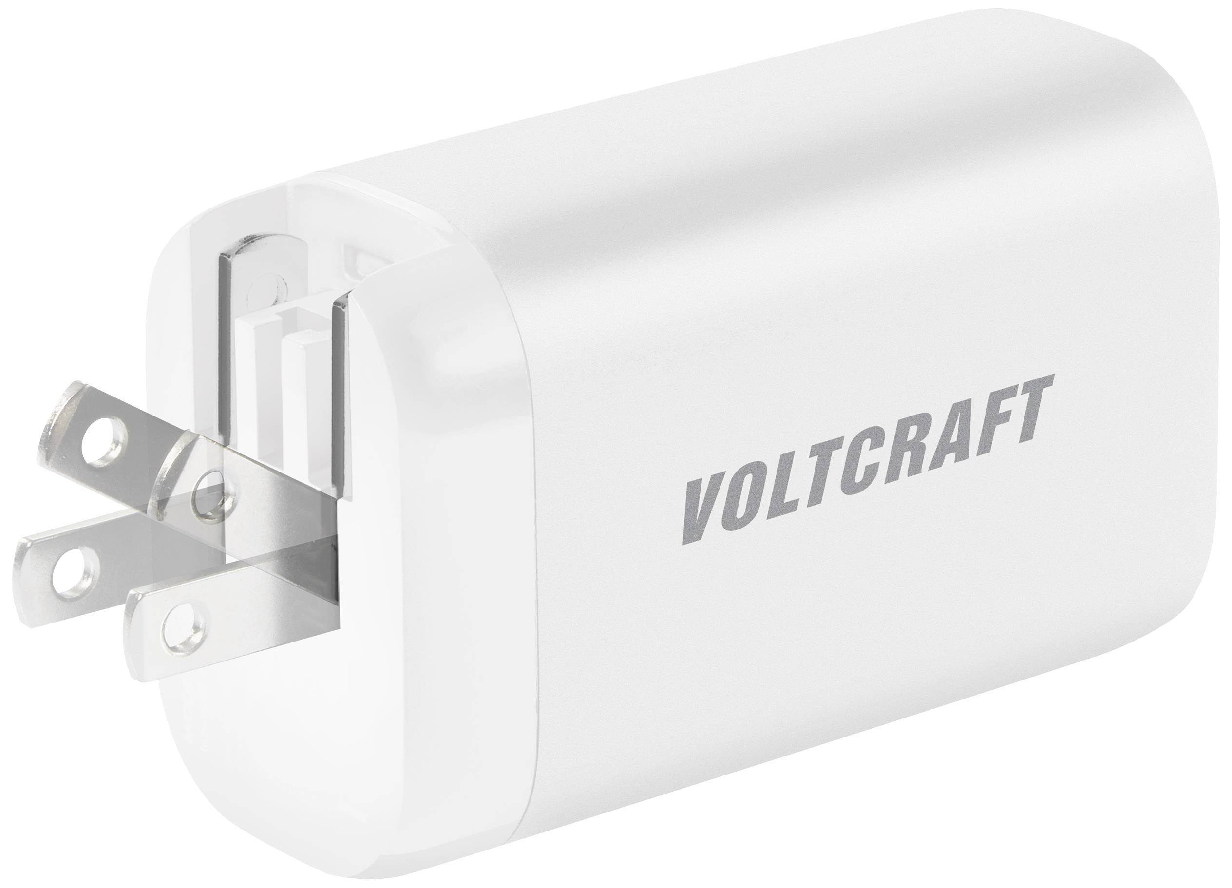 Ein weißes USB-Ladegerät mit zwei ausklappbaren Steckdosenkontakten der Marke 'Voltcraft'.