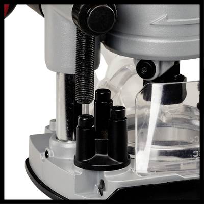 Ein Detail einer mechanischen Vorrichtung, möglicherweise eine Maschine oder ein Werkzeug, mit Metall- und Kunststoffkomponenten.