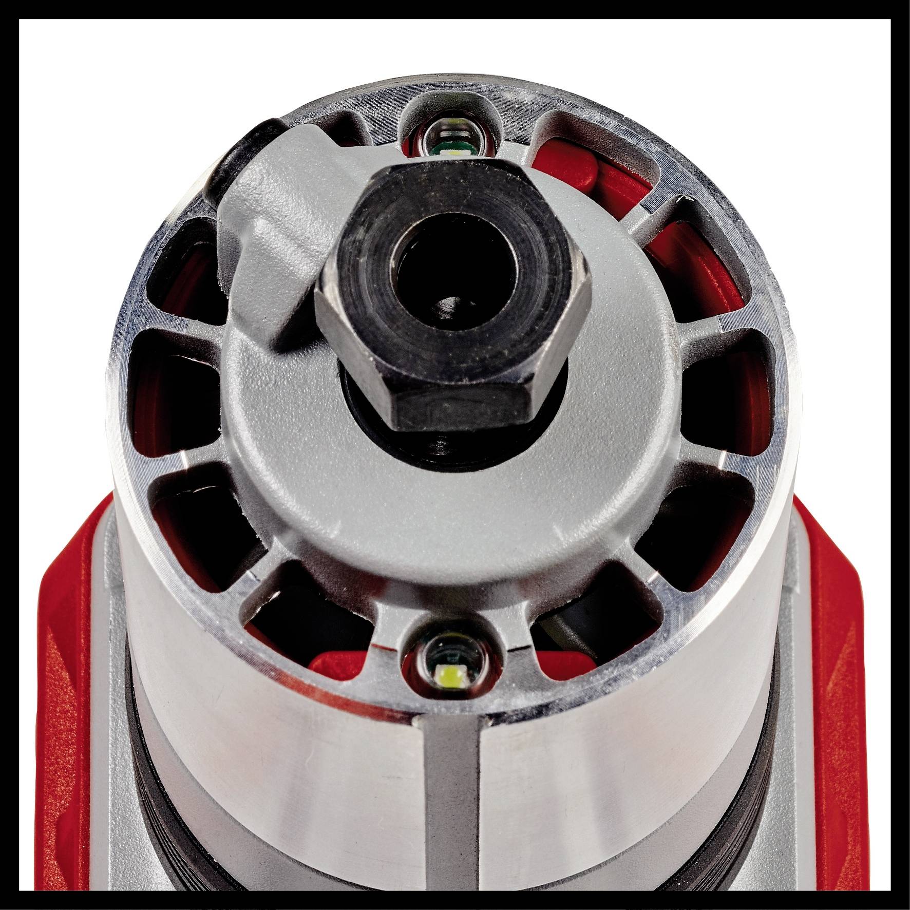 Nahaufnahme eines metallischen Industrie-Bauteils mit rotem Gehäuse, Rillen an der Seite und einer zentralen Schraubenöffnung oben.