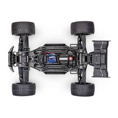 Ferngesteuertes Auto in Draufsicht; zeigt Chassis, Elektronik und Aufhängung. Vier große Reifen, schwarzes Design.