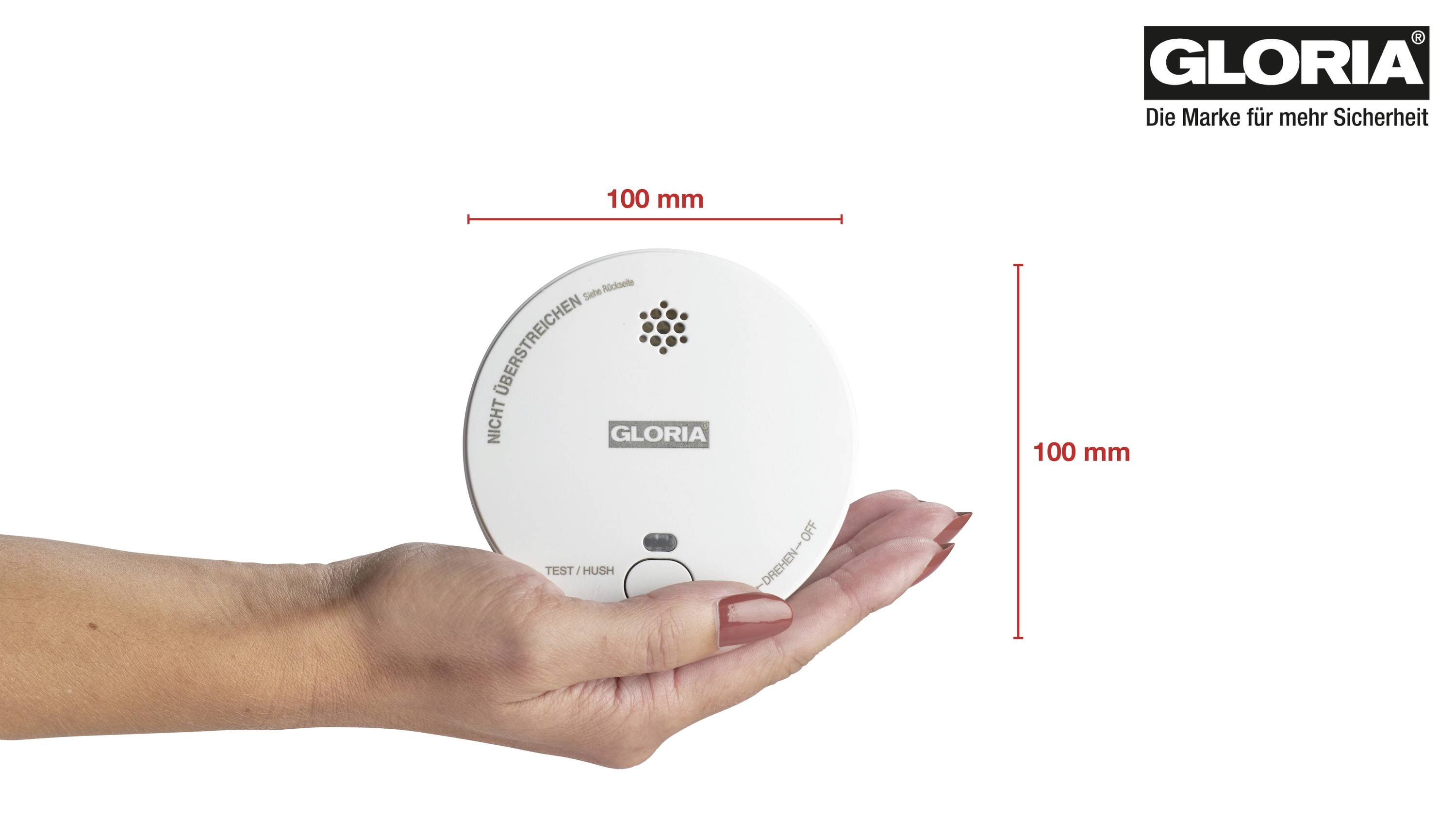 Eine Hand hält einen runden Rauchmelder mit der Aufschrift 'GLORIA'. Daneben steht '100 mm' als Größenangabe.