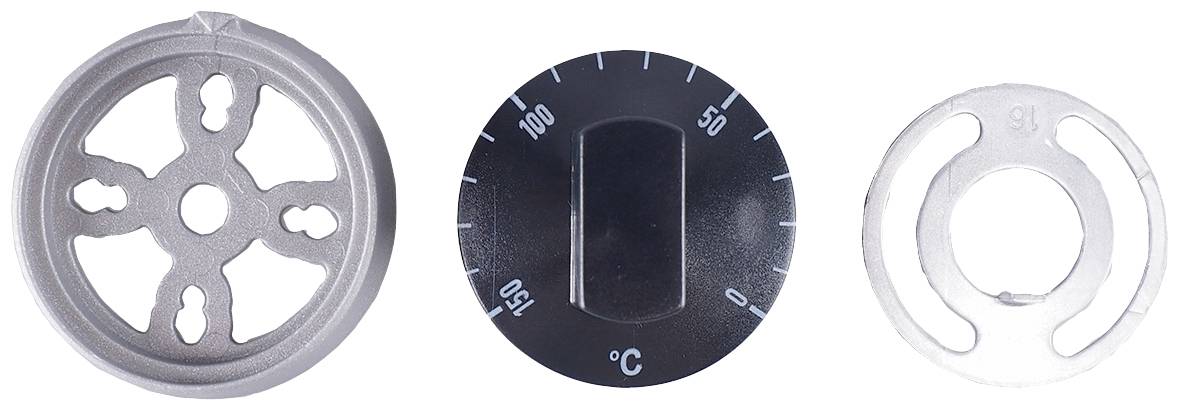'Drei Bauteile aus Metall und Kunststoff, darunter ein Zahnrad, ein Temperaturregler mit Skala von 0 bis 150 Grad Celsius, und ein Ring.'