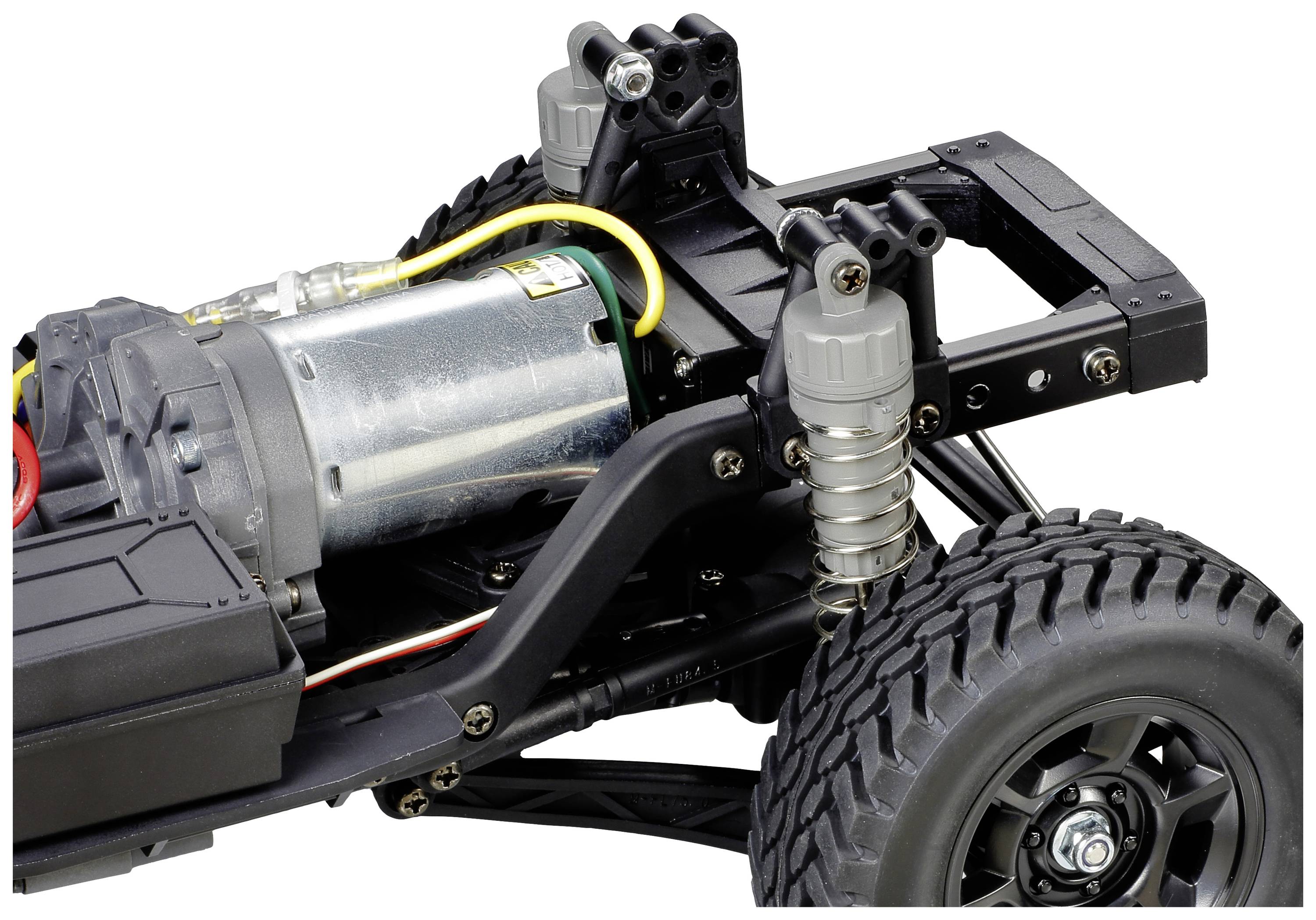 Elektrisches Modellauto-Chassis mit sichtbarem Motor und Stoßdämpfern. Das Rad ist groß und geländetauglich.