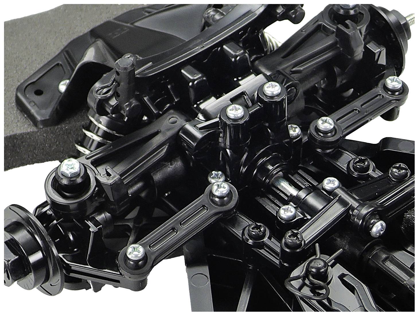 Nahaufnahme eines schwarzen komplexen mechanischen Teils mit Schrauben und Federn. Möglicherweise Teil eines Fahrwerks oder einer Maschine.