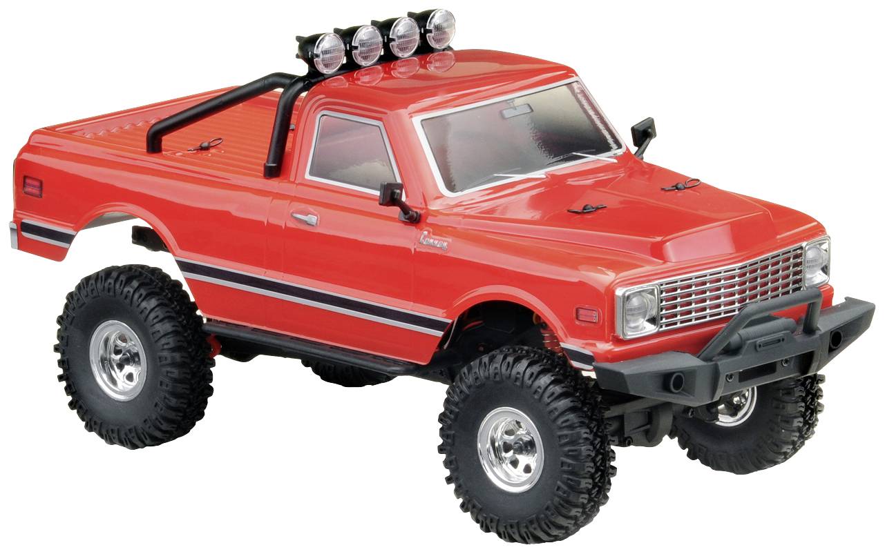 Ein roter Spielzeug-Geländewagen mit schwarzen Akzenten, robusten Reifen und vier Lichtern auf dem Dach, isoliert auf weißem Hintergrund.