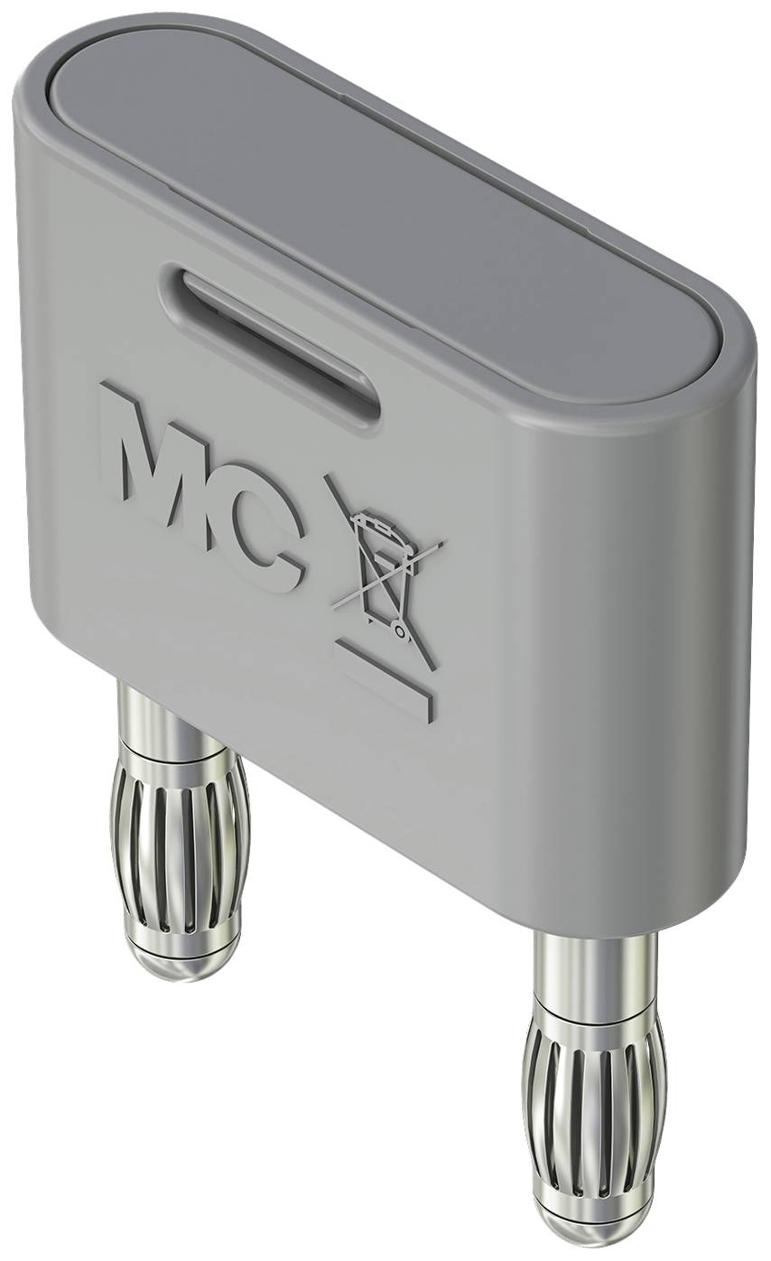 Ein grauer Kunststoffadapter mit zwei Metallsteckern unten, "MCX" und ein durchgestrichener Mülleimer sind auf der Oberfläche eingeprägt.
