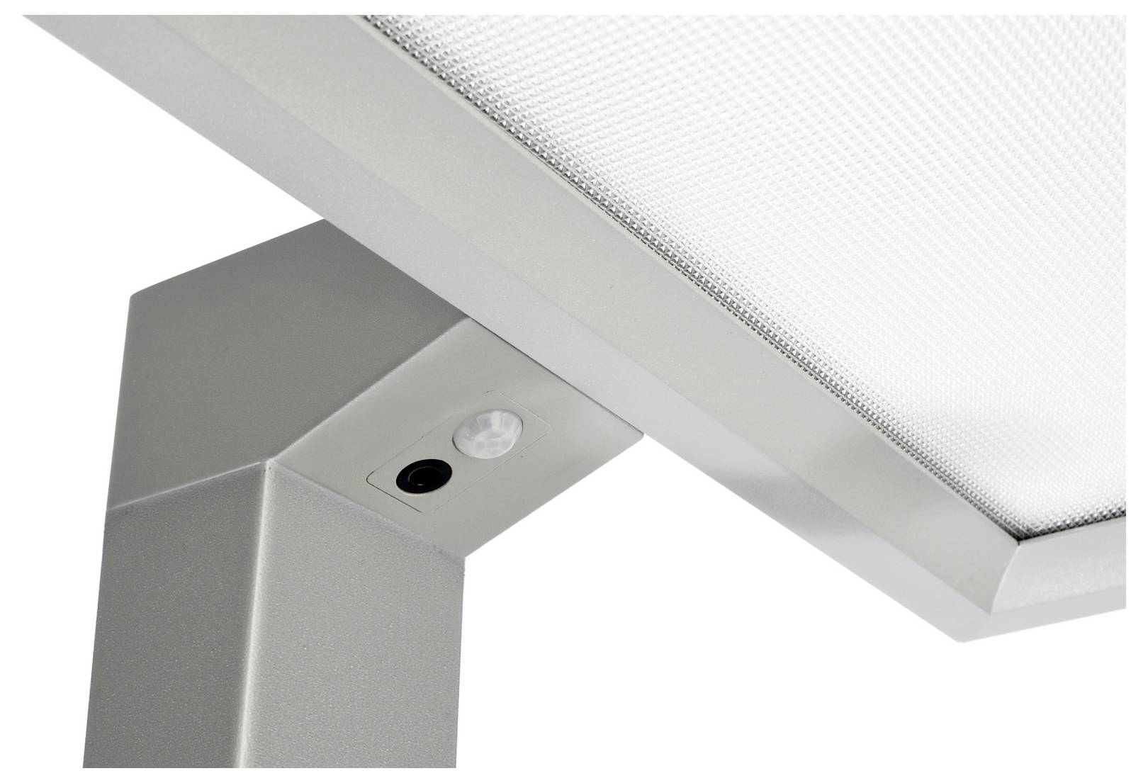 Nahaufnahme einer modernen Metalllampe mit strukturiertem Diffusor und zwei eingelassenen runden Leuchten.