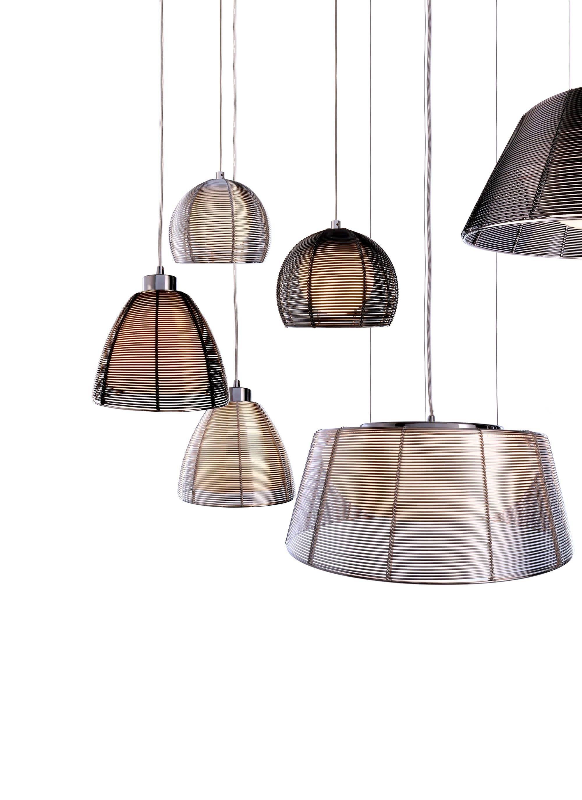 Fünf moderne, hängende Lampenschirme in Metalloptik, variierende Größen und Formen, vor weißem Hintergrund.