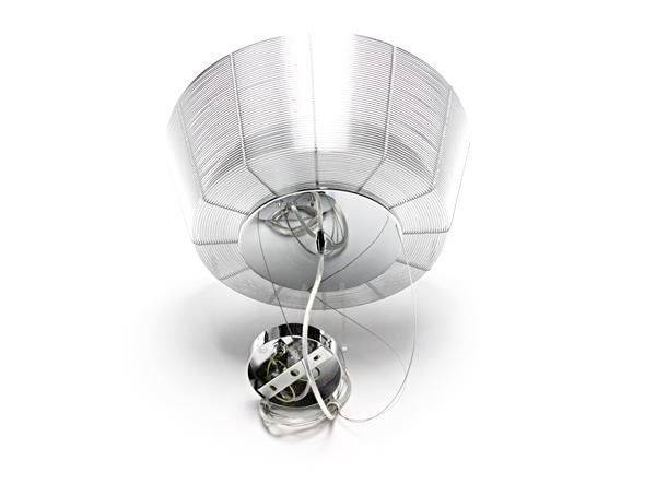 Ein moderner Deckenventilator aus Metall mit abgerundeten Kanten und sichtbarer Verkabelung liegt auf einer weißen Oberfläche.