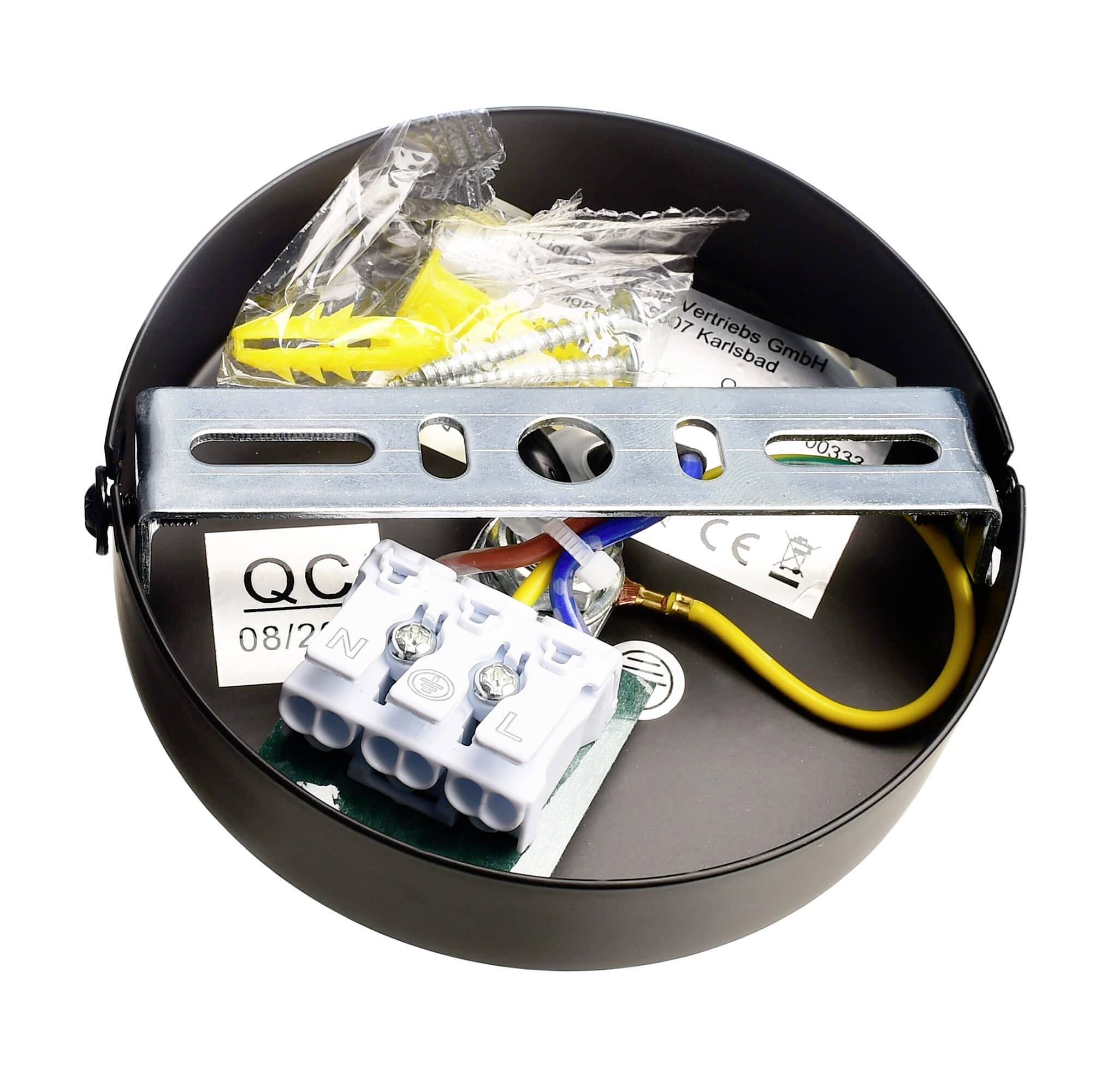 Runde schwarze Lampenfassung mit elektrischen Anschlüssen und Befestigungselementen. Verbindungsklemmen für L, N und PE sichtbar. Verpackungsteile beiliegend.
