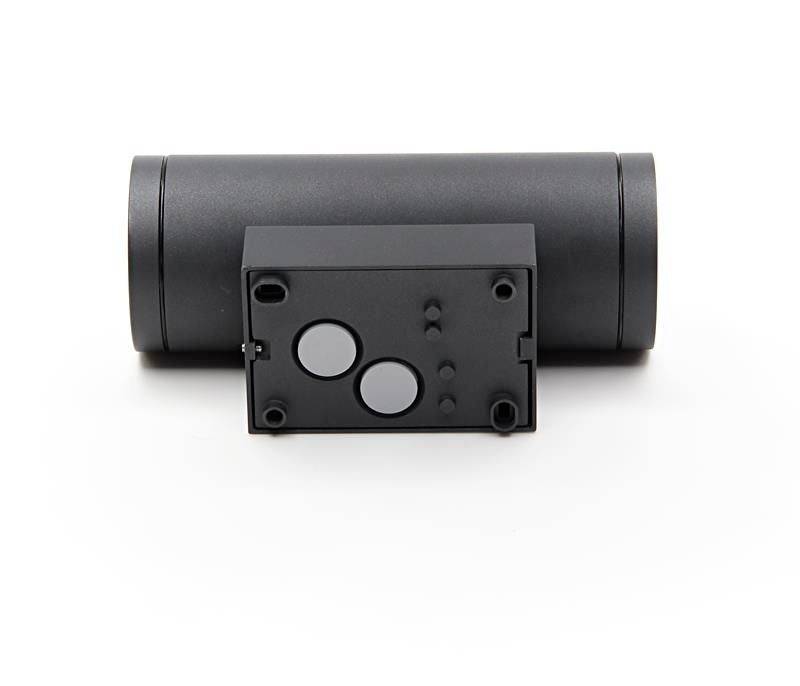 Schwarzes zylindrisches Gerät mit rechteckigem Teil, das zwei runde Sensoren zeigt. Möglicherweise ein technisches Produkt oder Werkzeug.