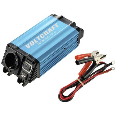 Spannungswandler (blaue Farbe) mit USB-Anschluss und Steckdose; daneben rote und schwarze Klemmen mit Kabel. Markenname 'Voltcraft'.