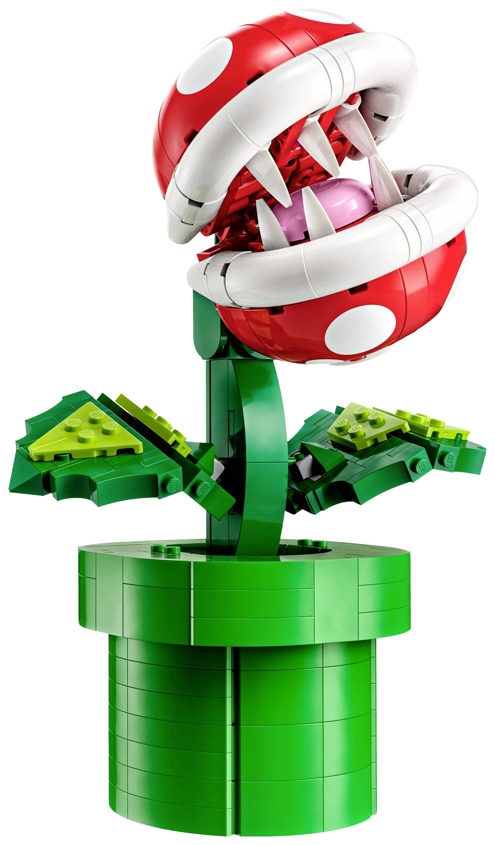 LEGO-Pflanzenfigur mit großem, geöffnetem Maul und weißen Zähnen, rot-weißem Kopf und grünen Blättern auf einem grünen Sockel.