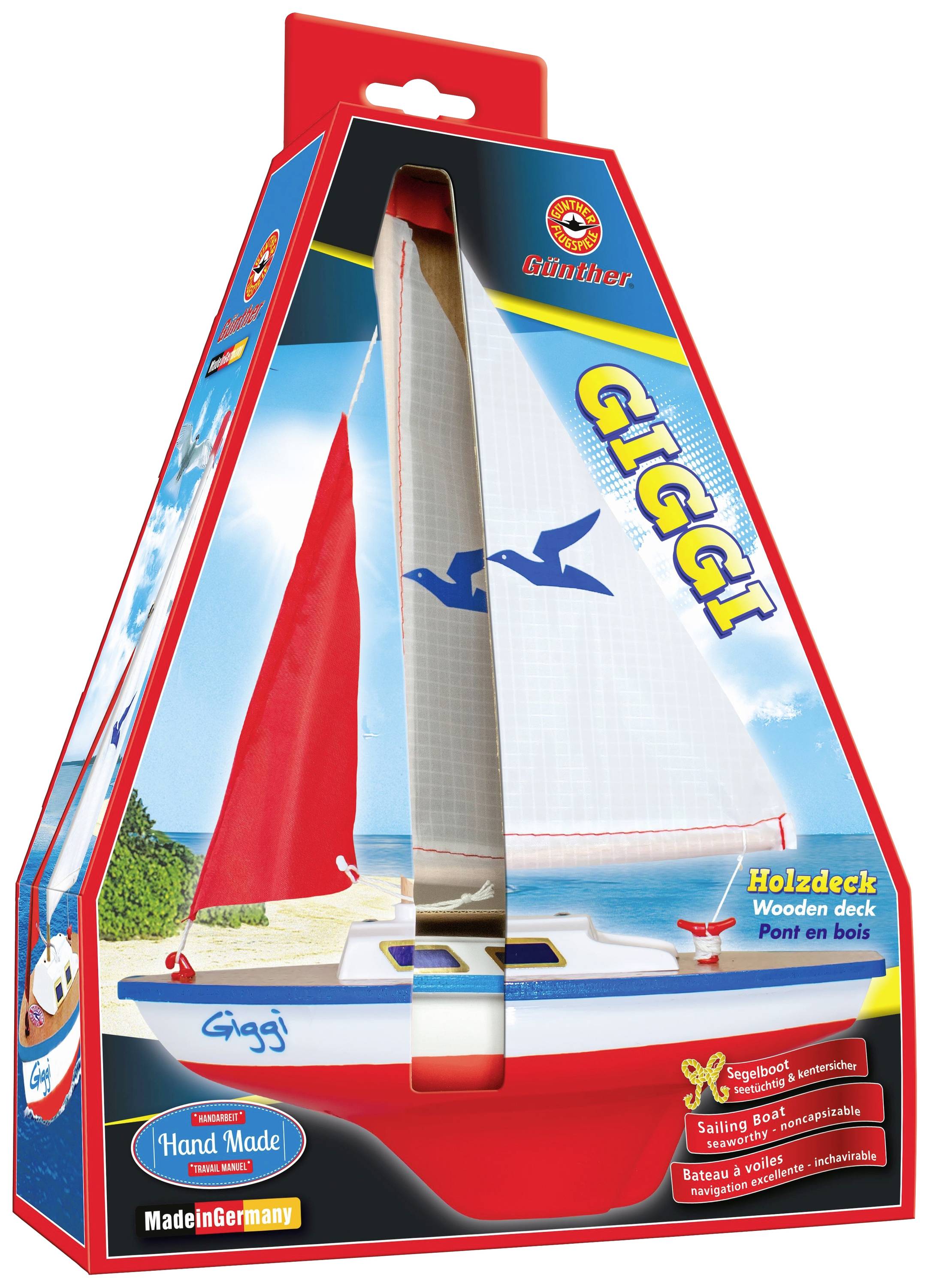 Verpackung eines Modellsegelboots 'Giggi' mit rotem Segel, blauem Rumpf und Holzdeck. Enthält Handgefertigt- und Made in Germany-Hinweise.