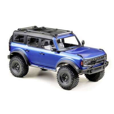 Ein blauer Geländewagen-Modell mit großem Dachgepäckträger und robusten Reifen, geeignet für Offroad-Abenteuer.