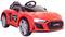 Ein rotes Spielzeugauto im Audi-Sport-Design mit leuchtenden Scheinwerfern, schwarzem Sitz und Einhell-Logo an der Seite.