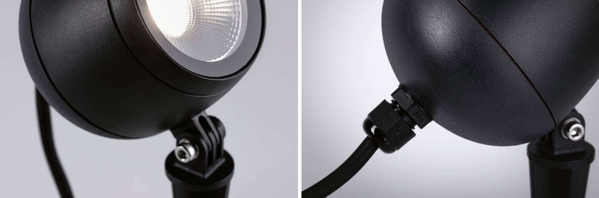 Nahaufnahme einer schwarzen, kugelförmigen Lampe mit sichtbaren Befestigungsdetails und einem Kabelanschluss.