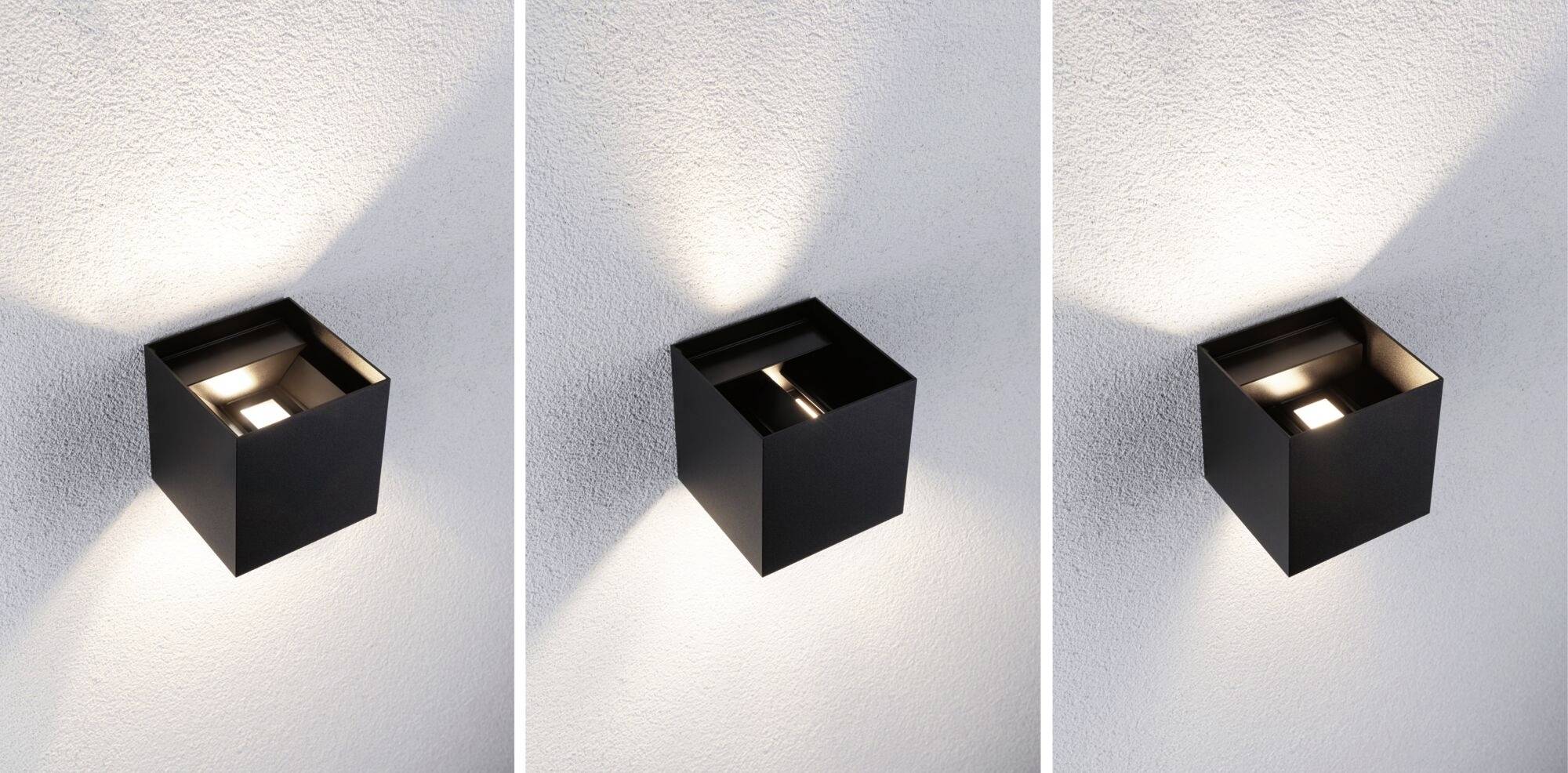 Drei schwarze Wandleuchten mit geometrischem Design strahlen jeweils unterschiedliches Lichtmuster an einer weißen Wand aus.