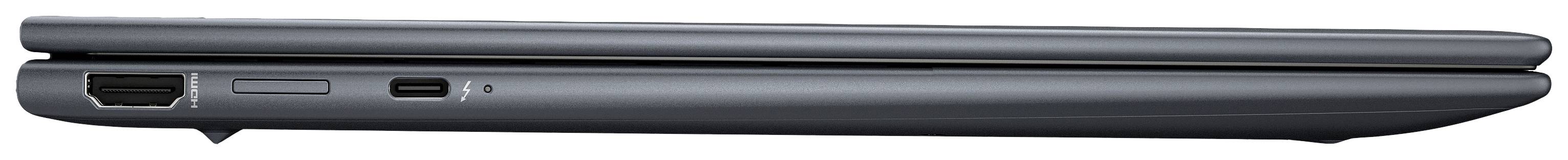 Ein seitlich geschlossener Laptop, dunkelgrau, mit sichtbaren Anschlüssen auf der linken Seite.