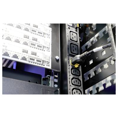 Nahaufnahme eines Serverracks mit mehreren eingepfropften Steckdosenleisten und Verkabelung, zeigt IT-Infrastruktur in einem Rechenzentrum.