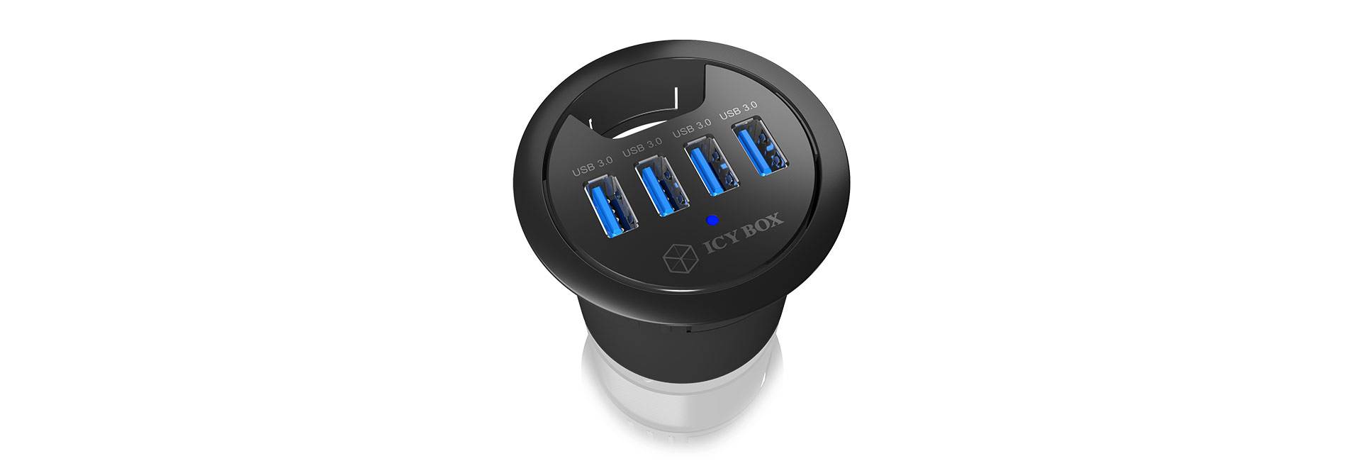 USB-Hub in runder Tischsteckdose. Drei blaue USB-Anschlüsse sichtbar. Designed für einfache Zugänglichkeit auf dem Tisch.