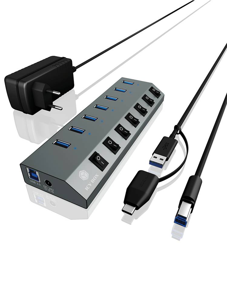 USB-Hub mit sieben Anschlüssen, jeweils mit einem Schalter. Enthält ein Netzteil und verschiedene Kabel, darunter USB-Typen A und C.