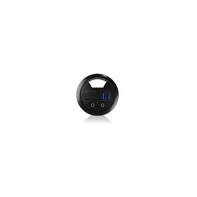 Ein schwarzer, runder USB-Hub mit zwei USB-Anschlüssen, zwei runden Audiobuchsen und einem USB-C-Anschluss.