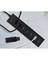 Schwarzer USB-Hub mit fünf Anschlüssen, an dem drei Kabel angeschlossen sind; ein USB-Stick liegt daneben. Oberflächenstruktur sichtbar.