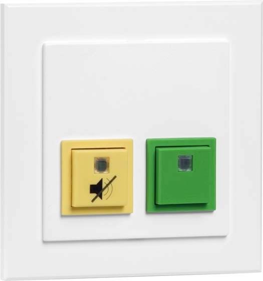 Ein Wandschalter mit zwei Knöpfen: links ein gelber mit Stummsymbol, rechts ein grüner. Schalter sind eingebaut in eine weiße Platte.