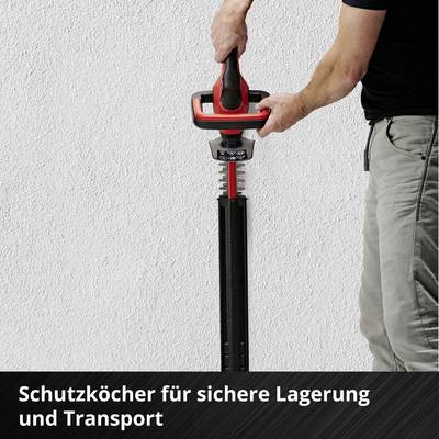 Person hält elektrisches Werkzeug mit Schutzklinge an der Wand. Text im Bild: 'Schutzköcher für sichere Lagerung und Transport'.