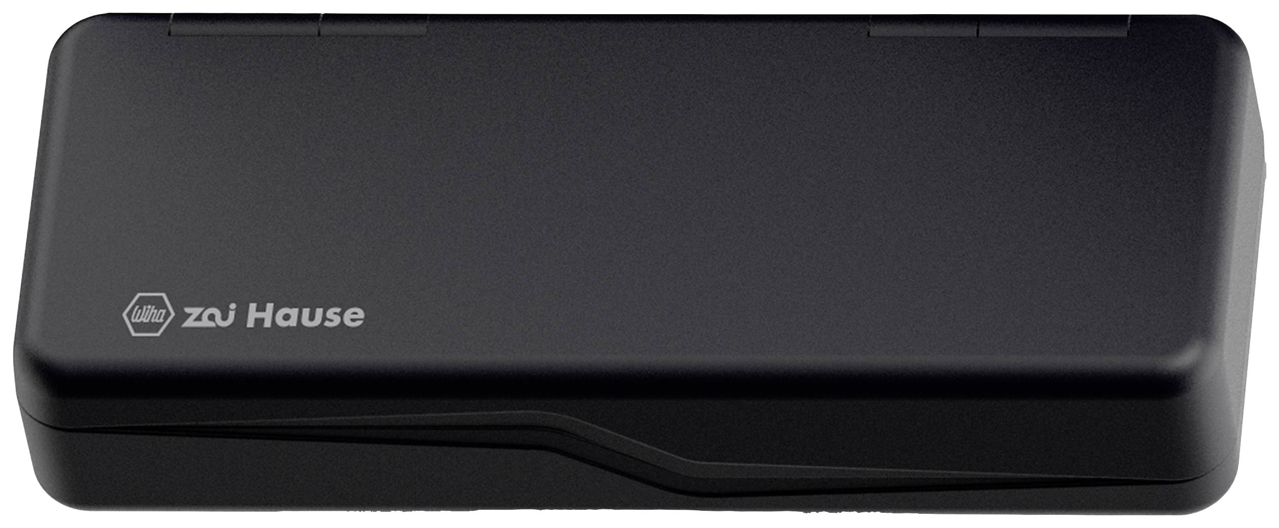 Schwarzes Gerät mit der Aufschrift 'zu Hause' auf der linken Seite. Es sieht aus wie ein Schalter oder ein technisches Gerät.