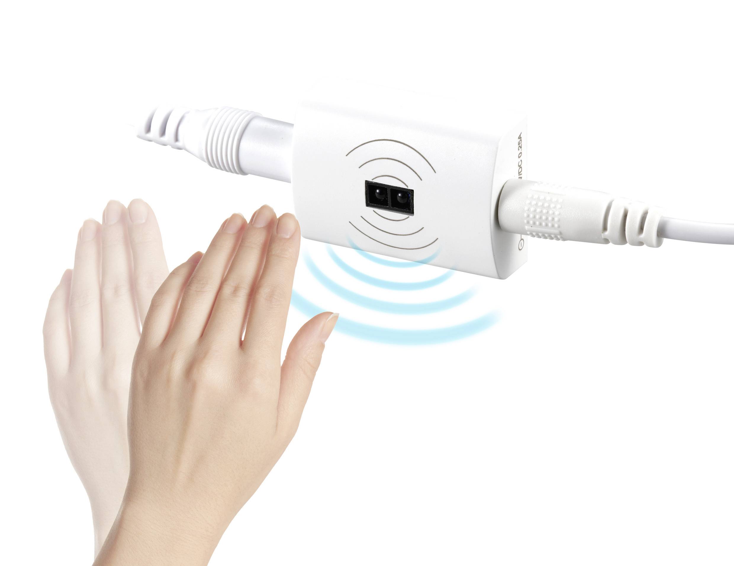 Eine Hand nähert sich einem Sensor an einem elektrischen Gerät mit Kabeln, der Wellen zur Berührungserkennung ausstrahlt.