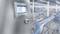 Industrieanlage mit einem Bedienfeld im Vordergrund; zeigt Produktionsprozess für Abfüllung von Plastikflaschen in Fabrikumgebung.