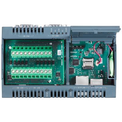 Ein offenes elektronisches Gerät mit grünen Klemmenleisten auf der linken Seite und einer Schaltplatine mit verschiedenen Anschlüssen rechts.