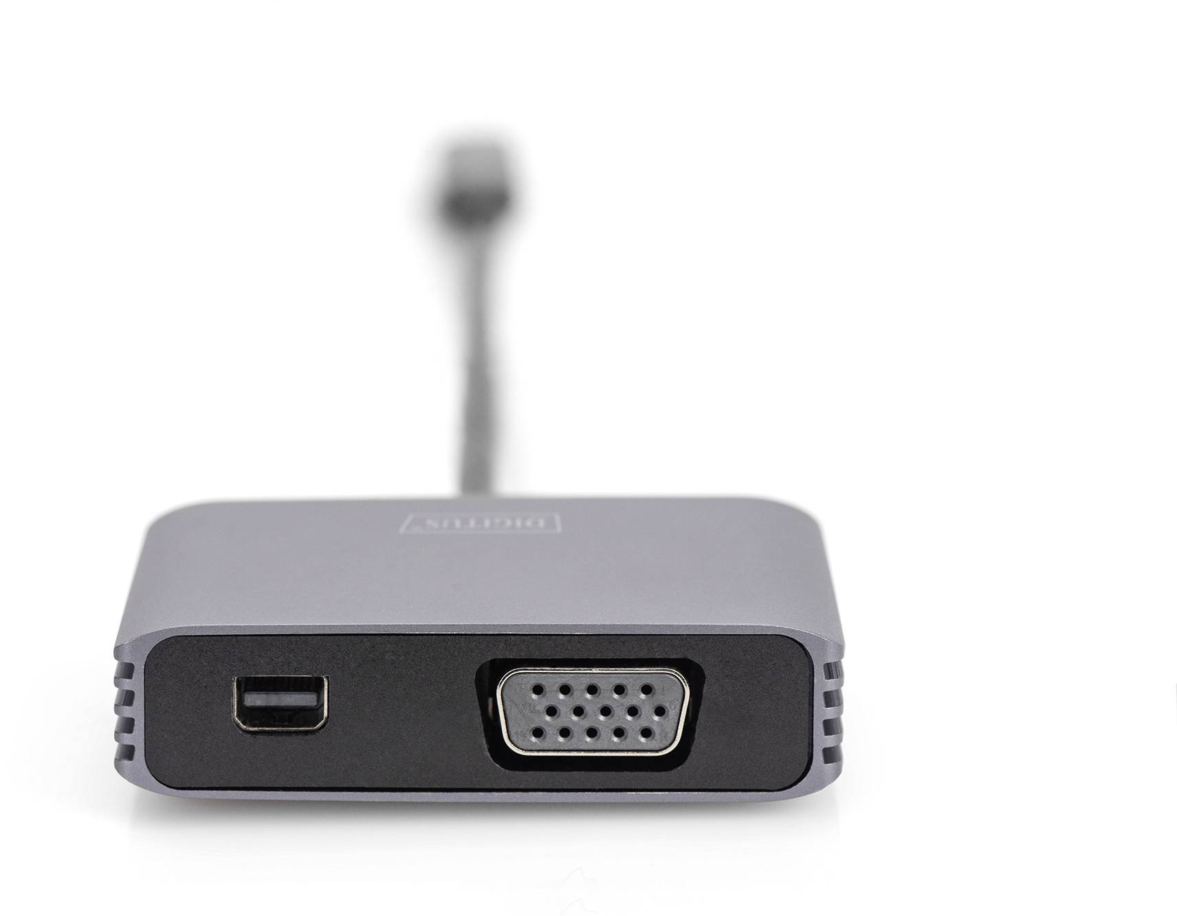 Ein VGA-Adapter mit einem USB-Anschluss auf der linken Seite und einem VGA-Ausgang auf der rechten Seite, grau und kompakt.