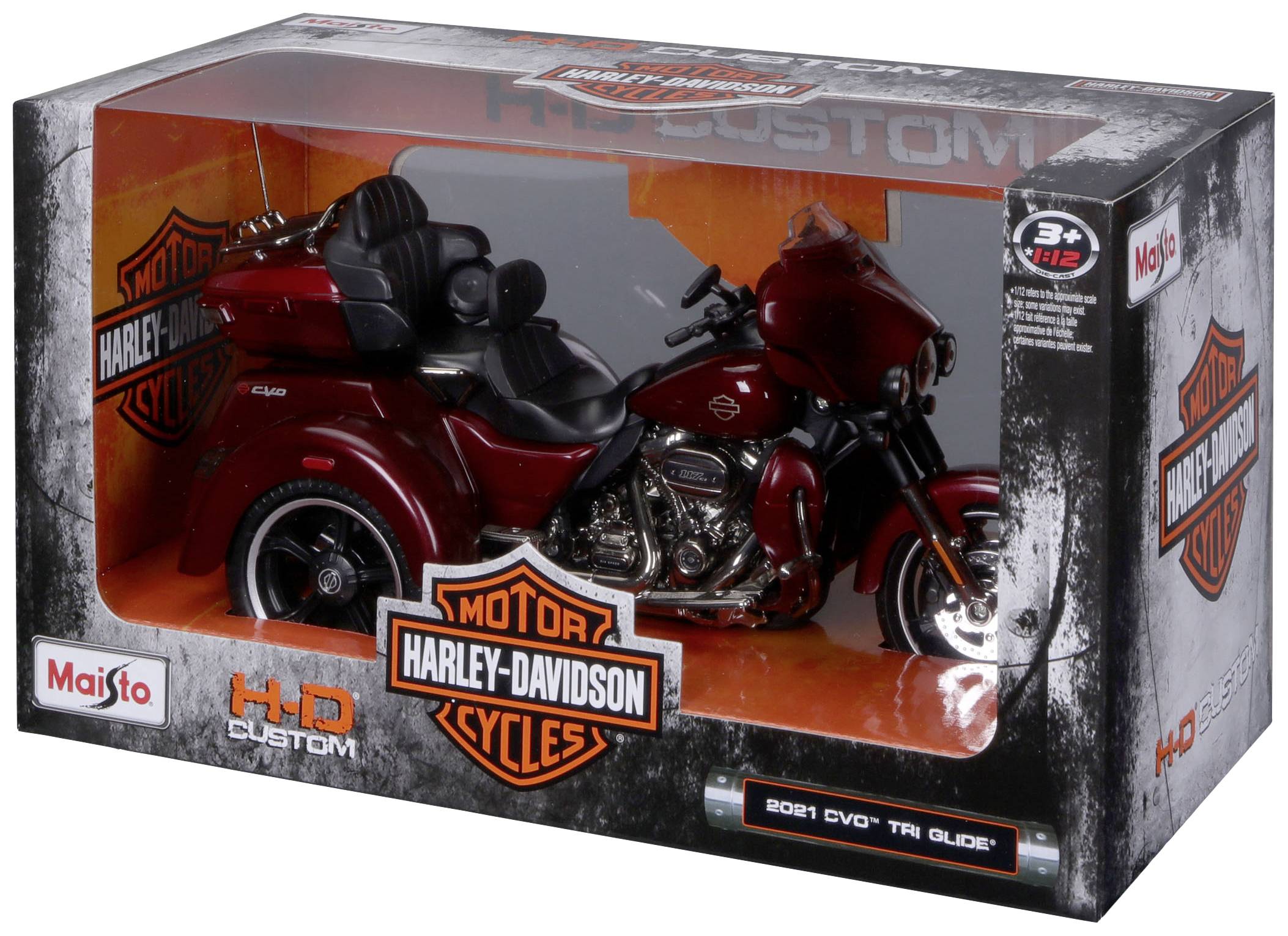 Spielzeugmodell eines Harley-Davidson Motorrads in einer Verpackung. Das Modell ist rot und besteht aus einer detailreichen Nachbildung mit Sitz und drei Rädern.