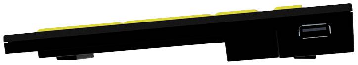 Ein seitlich fotografiertes, flaches, rechteckiges elektronisches Gerät mit mehreren gelben Tasten und einem Anschluss an einem Ende.